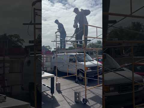 Students learn how to hoist objects from a scaffold.