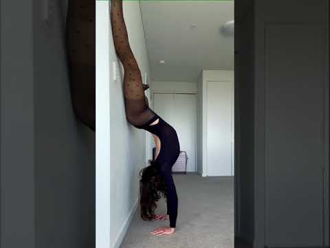 Handstand In Bodysuit and Black Pantyhose