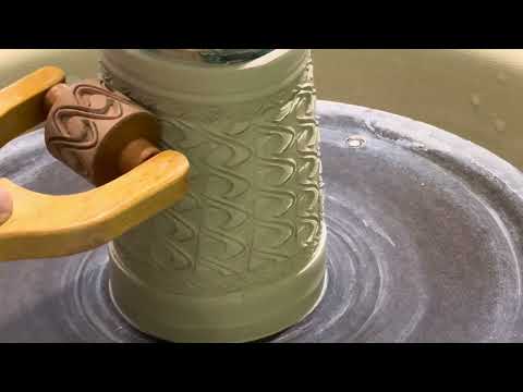 Throwing and texturing a mug on the pottery wheel