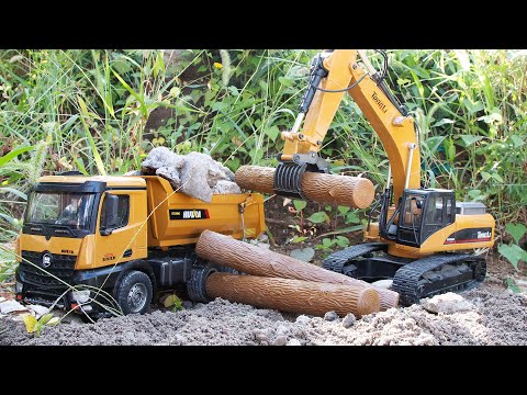 RC excavators dump trucks Remote controlled tongs excavators and dump trucks carrying dirt rocks