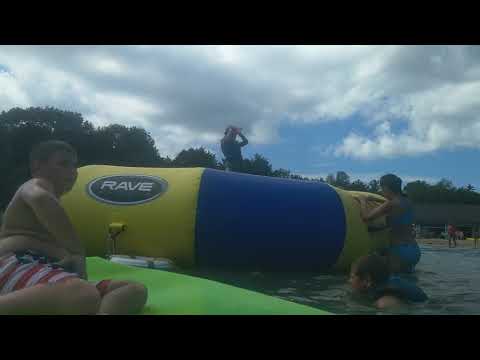 Lucy jumping off the big trampoline into the water