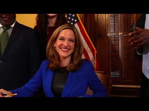 Secretary Benson signs legislation as acting governor