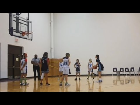 Basketball game in tournament 2nd half of a tough game but still working hard and playing toughness