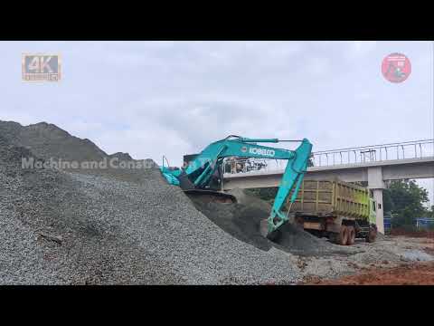 EXCAVATOR WORK ON ROAD CONSTRUCTION! KOBELCO SK200 EXCAVATOR LOADING GRAVEL INTO THE TRUCK