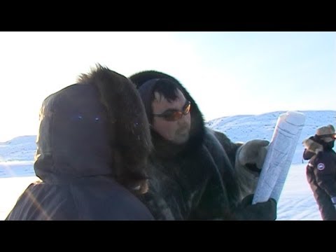 Charlie and his Inuit friend consulting the map - Penny Icecap 2009 expedition