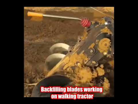 Backfilling blades working on walking tractor