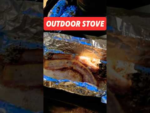 Cooking bacon on an outdoor wood burning stove #camping #cooking