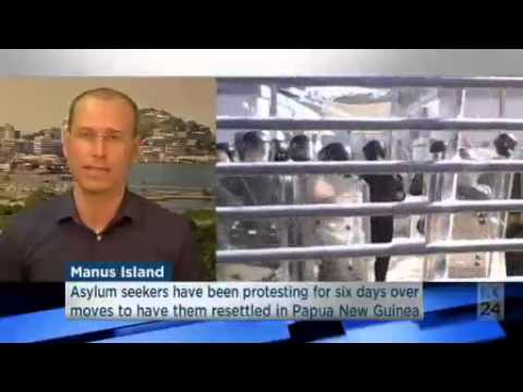 Video 1:22
         Asylum seekers burrow under a fence to reach water