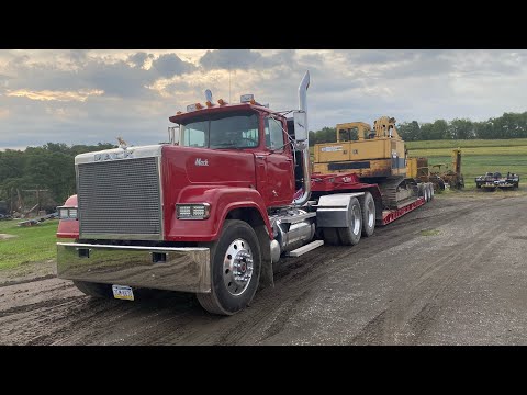 Trucking, Clearing, and Digging with Cat 215 Excavator