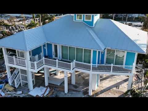 Ft Myers Beach, FL One home with no damage in sea of debris from Hurricane Ian