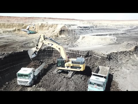 Aerial View Of Several Excavators With A Fleet Of 4 Axle Trucks Working On Mines - Interkat SA