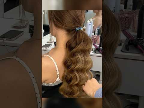 Sleek ponytail with waves