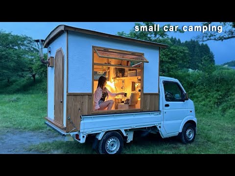 Enjoying the sound of rain and movies through the big windows of a small car (raincarcamping)