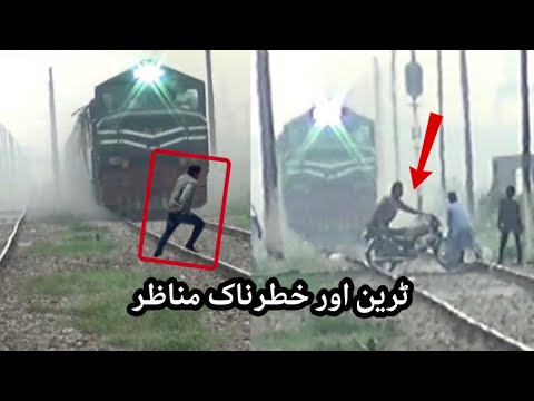 Business Express Train On The Way & Crazy Biker Crossing The Railway Track