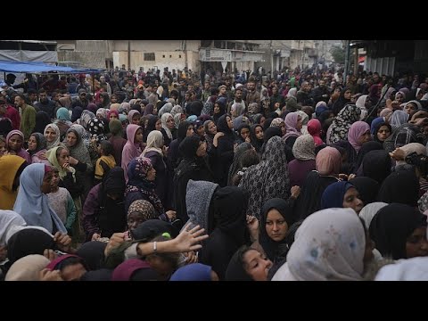 Palestinian children line up in Gaza Strip hoping to be distributed a warm meal