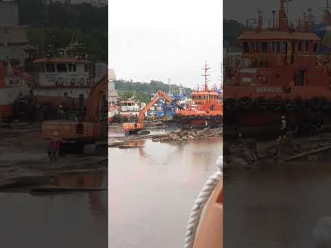 Watching 2 Hitachi excavator pulling barge ship