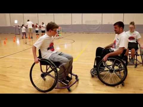 Paraplegic Assisting at an Inclusive Youth Sports Festival