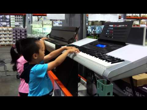 Arthur playing piano in Costco 2013--7-13