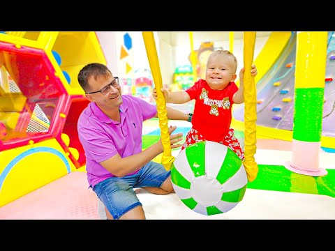 Oliver plays on the playground with Mom and Dad