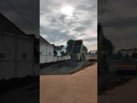 TRUCK UNLOADING GRAVEL FOR ROAD CONSTRUCTION