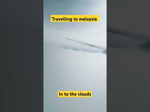 Traveling to Malaysia, a plane in the clouds