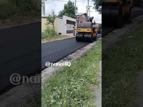 tandem roller compacting new asphalt layer