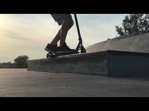 Scooter grind at skatepark