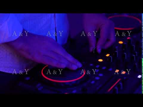 DJ controls the music console in a nightclub.