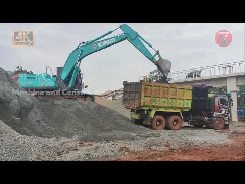 Kobelco sk200 excavator loads lots of gravel into the Hino truck