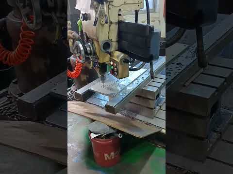 semi automatic NC drilling machine is machining a piece of tool steel into desired product