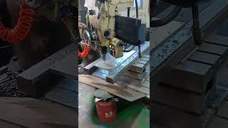 semi automatic NC drilling machine is machining a piece of tool steel into desired product