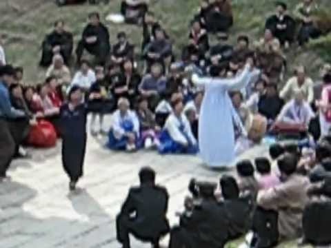 North korea dancing in park.