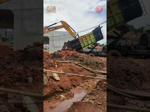 Truck Unloading Dirt with Excavator