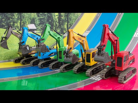 A rainbow colored RC excavator plays on a rainbow colored slide