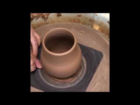 Wheel throwing and altering a pumpkin mug on the potter’s wheel.