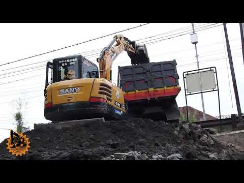 Sany mini Excavator loading debris on a dump truck