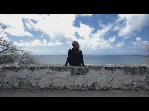 Woman Sitting by Ocean | Copyright Free Video Footage