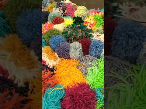 The Mossy Carpet's glorious colourful pompoms on display at Eden Project's Festival of Imagination