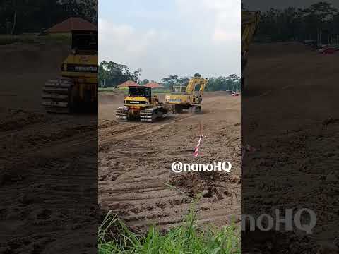 pc200 excavator and dozer prepare for rest after long day working on toll road