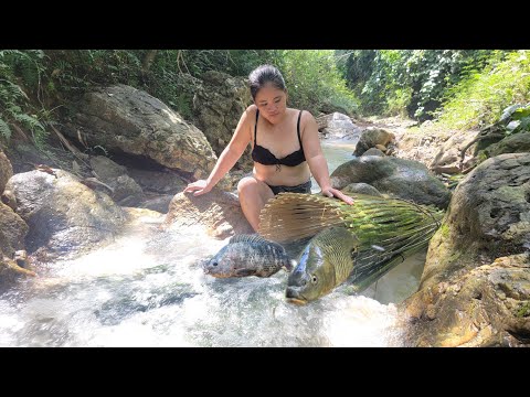 The girl went to the stream and caught huge carp and tilapia.