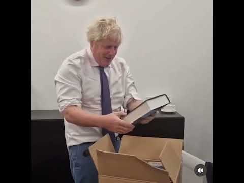 Boris Johnson opens a box full of copies of his book