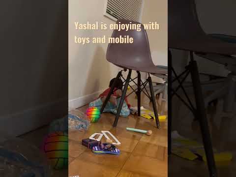 Yashal is enjoying with toys and mobile