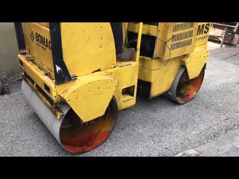 BOMAG TANDEM ROLLER COMPACTING MACADAM ROAD