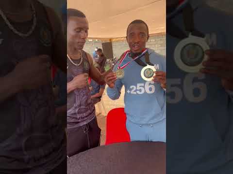 LIGHT MIDDLE ISAAC SENYANGE Jr. Presents Two gold Medals He Won In UK To UBF President Moses Muhangi