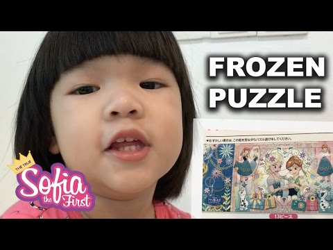 Sophie playing with puzzle of Disney's Frozen (Queen Elsa, Princess Anna, Olaf)