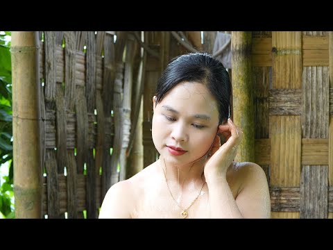 Lush rice fields are tended by a girl, bathing and cooking after a day of work