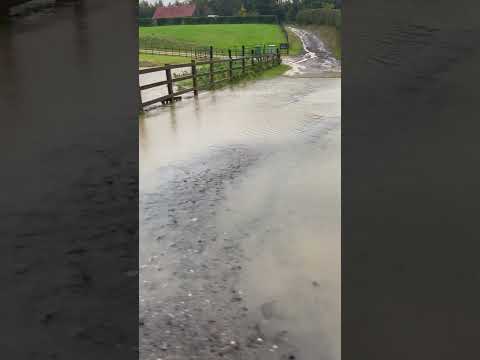 Storm Babet causing flooding over the top of a bridge (uk)