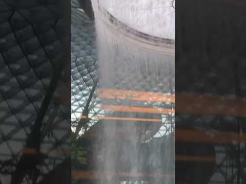 View of Jewel Changi waterfall at Changi Airport in Singapore from the inter-terminal Skytrain!