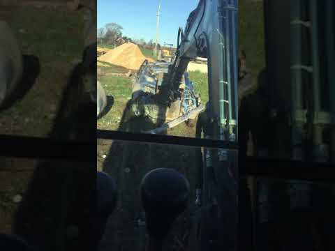 Car engine removal using a digger