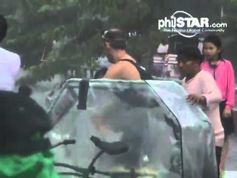 australian tourists swimming in floodwaters in the philippines